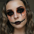 Person with Halloween-themed makeup featuring a nose patch and black eyeliner.